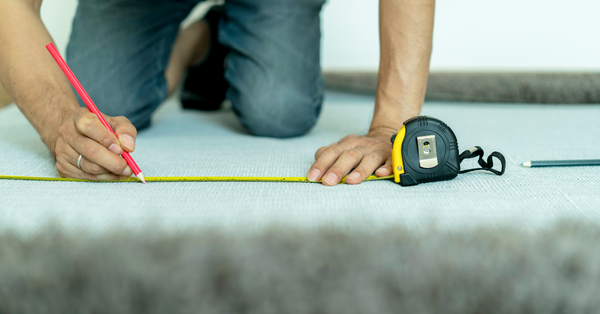 measuring carpet on floor
